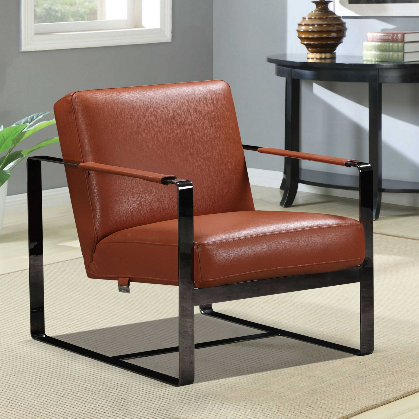 sleek chair with black metal frame and camel leather