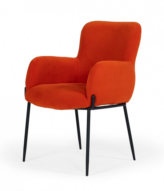 orange velvet chair with black metal tapered legs